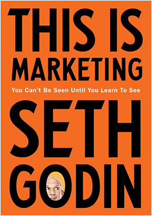 Tämä on kuvakaappaus Seth Godinin kansiosta This Is Marketing. Kansi on pystysuora suorakaide, jossa on oranssi tausta ja musta teksti. Sethin pään kuva näkyy hänen sukunimensä O-kirjaimessa.
